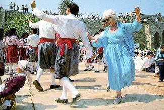 A tourist joins in the dance during a folk dancing event at Kyrenia Castle, North Cyprus